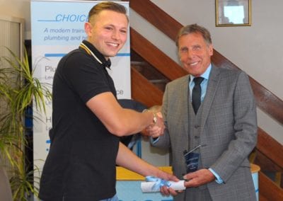 Choice Training Director Robert Maw presents the Choice Plumbing Apprentice of the Year award to Davis Peck